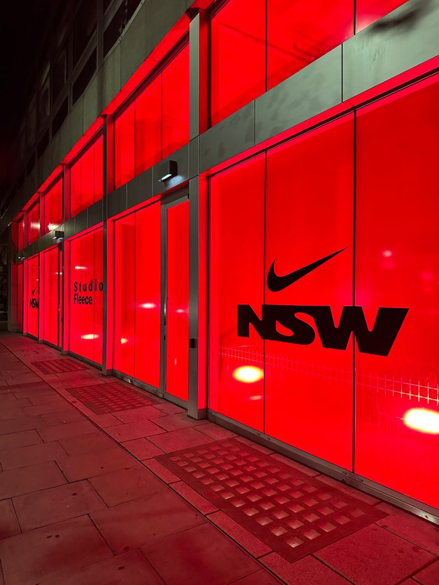 The Nike Studio Fleece shopfront at night, glowing red with Nike NSW and Studio Fleece on the windows